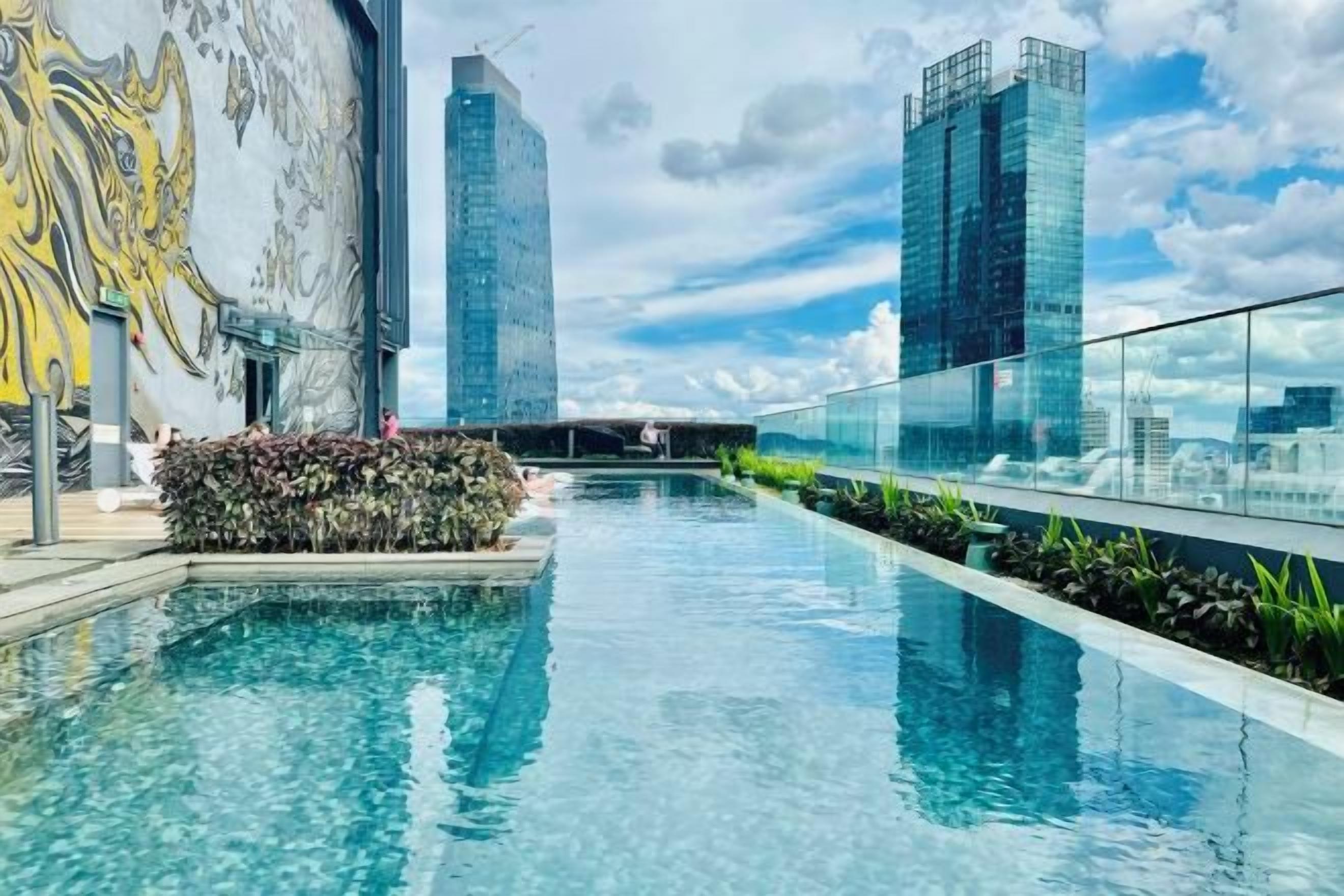 A swimming pool with a cityscape view, surrounded by modern buildings.