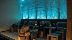 A massage room with reclining chairs, a wall-mounted screen, and a small table. - Hotel Brynton at Cameron Centrum Mall (Brinchang)