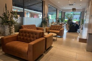 A lobby with seating, a reception desk, and large windows. - Hotel Brynton at Cameron Centrum Mall (Brinchang)