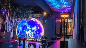 A restaurant with a large illuminated globe, modern furniture, and ambient lighting. - Hotel Brynton at Cameron Centrum Mall (Brinchang)