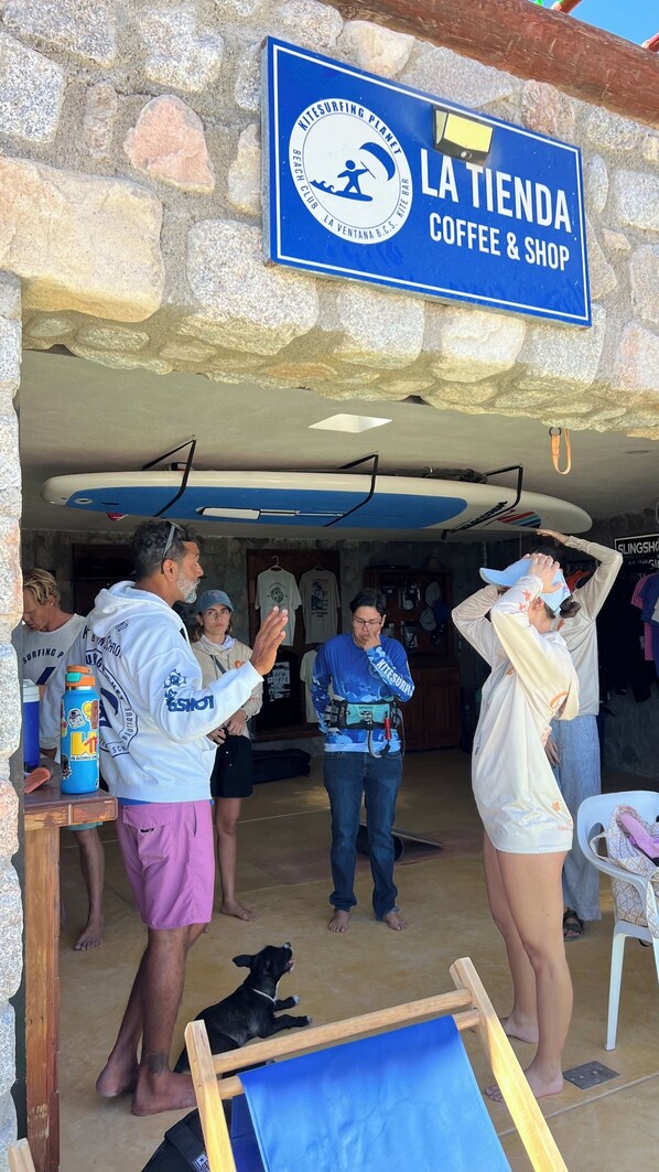 A stone building with a sign reading "LA TIENDA COFFEE & SHOP". - Azul Beach Kite Resort (El Sargento)