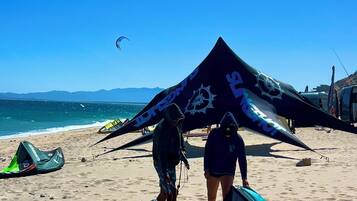 On the beach, white sand, sun-loungers, beach umbrellas