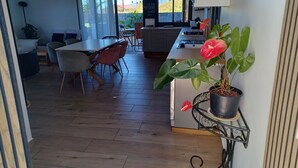 A modern kitchen with a dining area, wooden flooring, and potted plants. - Les trois songes Villa where partying is tolerated in the countryside  (Saint-Pierre)