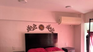 A bedroom with a bed, a nightstand, a dresser, and decorative wall art. - Beatiful aparment in the magical town of Orizaba 2 (Orizaba)