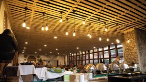 A buffet setup with various food items and serving equipment. - Mountain Gorilla View Lodge (Kinigi)