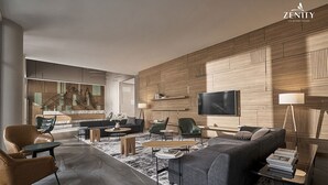 Una sala de estar moderna con un sofá, sillas, una mesa de centro y un televisor montado en la pared.