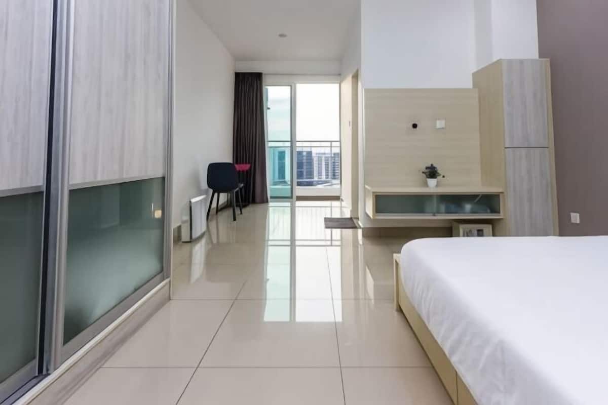 Une chambre d’hôtel avec un lit, un bureau, une chaise et une vue sur la ville.