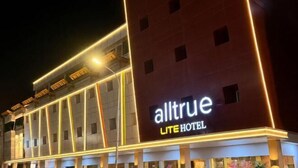 Un hôtel doté d’une enseigne bien visible indiquant « alltrue LITE HOTEL » et présentant une architecture moderne.