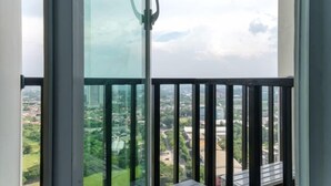 A high-rise building with large windows offering a cityscape view. - Gala by TwoSpaces Studio @TreePark Apartment (Serpong)