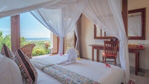 A bedroom with a bed, a desk, and a chair, all in a room with a view. - Villa Mata Hari (Sukasada)