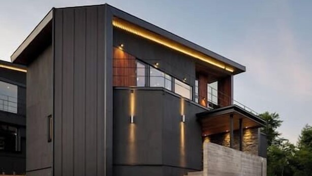 A modern two-story house with a dark exterior, large windows, and a staircase leading to the upper level. - Rinzan Chalet | 3BR Soga Chalet | Onsen-Style Bath & Yotei View (Rinzan)