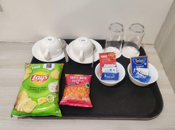 A tray with snacks, coffee, and tea. - The Denary Suites (Bhopal)
