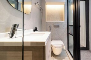 A modern bathroom with a large mirror, a sink, a toilet, and a shower area. - Heritage Collection on Pagoda - Mobile App Check-In (Singapore)