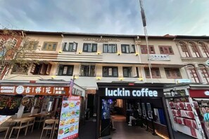 A multi-story building with a Heritage Collection sign, a Luckin Coffee shop, and various storefronts. - Heritage Collection on Pagoda - Mobile App Check-In (Singapore)