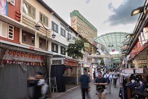 A bustling street with shops and a covered walkway. - Heritage Collection on Pagoda - Mobile App Check-In (Singapore)