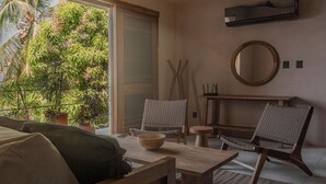 A cozy room with a wooden table, two chairs, a bowl, and a mirror on the wall. - Punta Morelos (Brisas de Zicatela)