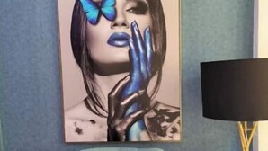 A room with a blue wall, a white table, and a framed artwork depicting a person with a butterfly. - Eve's Vista 2 bedroom apartment, Nanyuki- Kenya (Nanyuki)