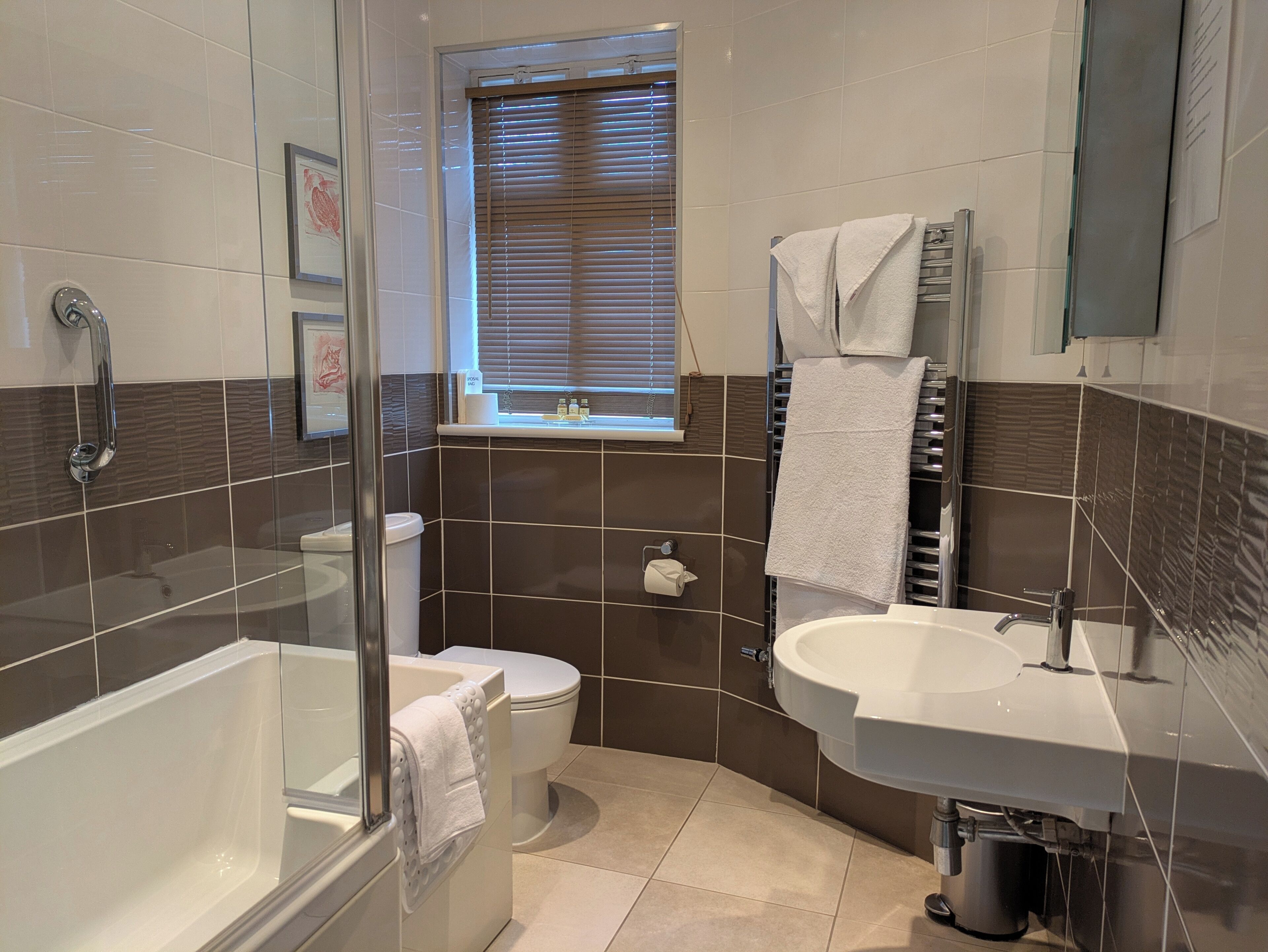 A modern bathroom with a bathtub, toilet, and sink.