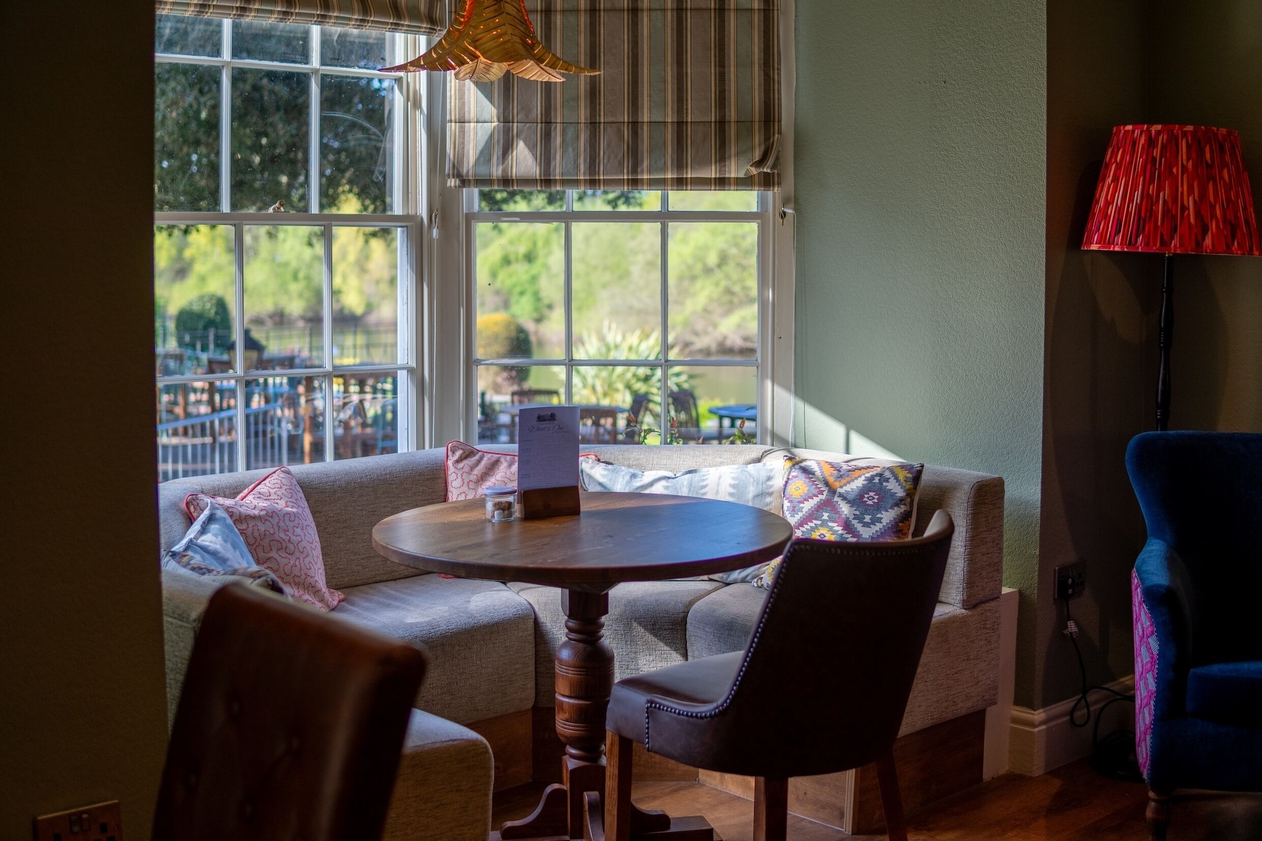 A cozy seating area with a round table, a sofa, and a chair.