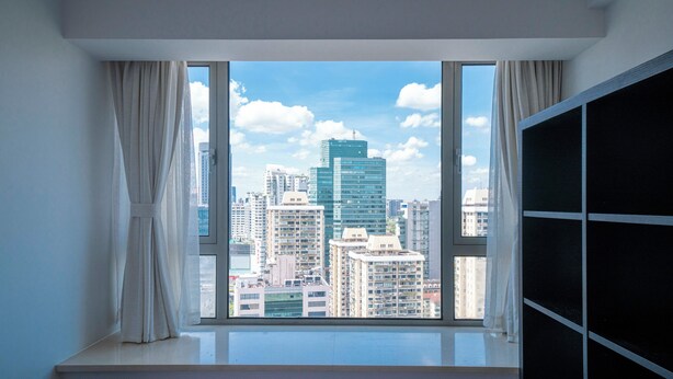 A room with a large window offering a city view. - Tyms Family 3BR 2BA Apt Xujiahui Metro (Shanghai)