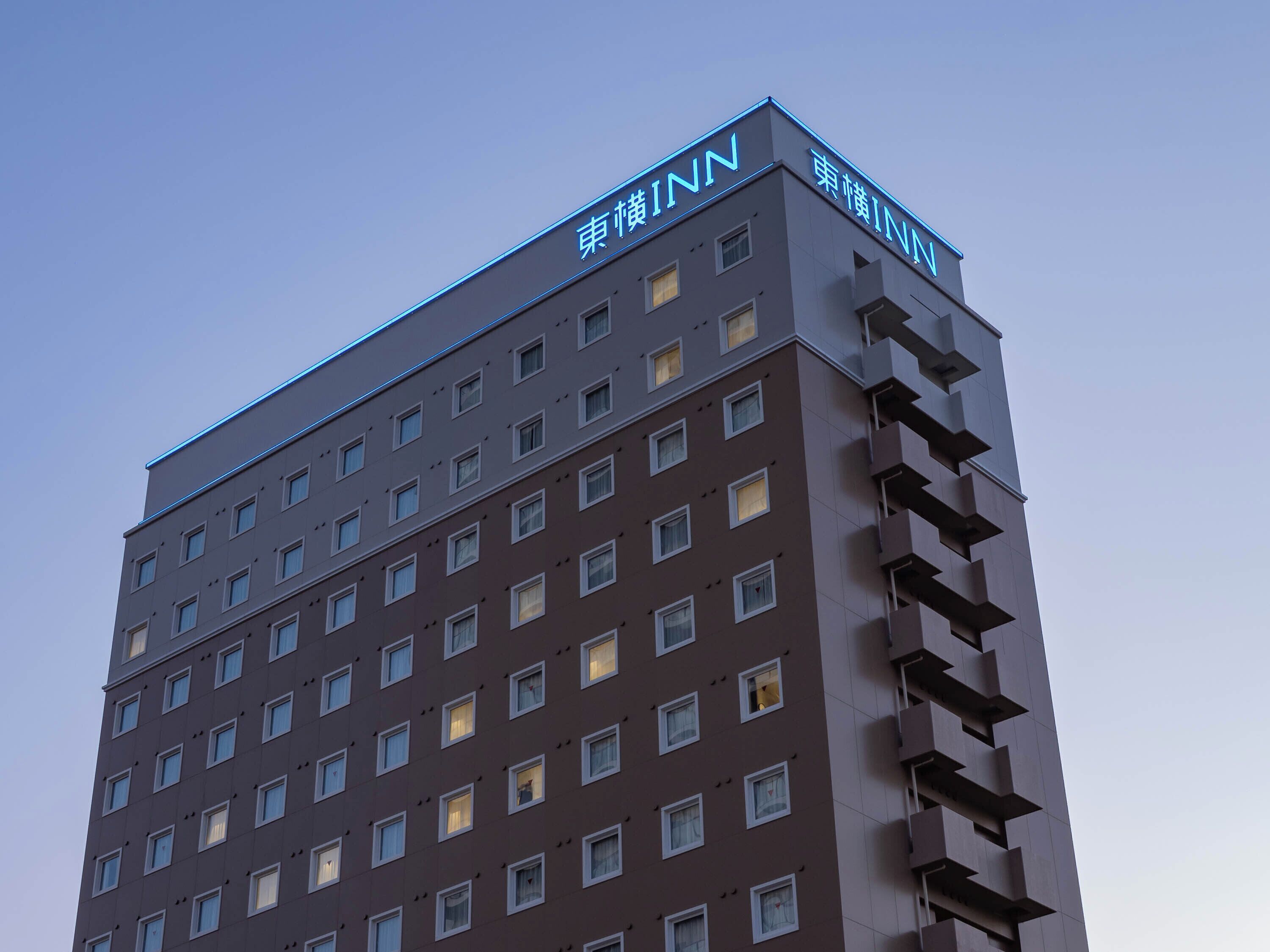 A multi-story hotel building with a modern design, featuring numerous windows and balconies.