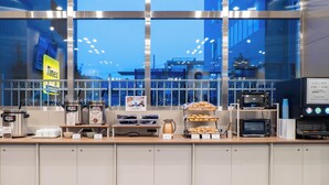 A breakfast counter with coffee machines, a microwave, and a menu board. - Toyoko Inn Tokorozawa-eki Nishi-guchi (Tokorozawa)