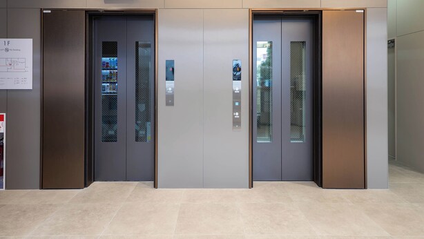 Two elevator doors with digital displays, a no-smoking sign, and a vending machine inside. - Toyoko Inn Tokorozawa-eki Nishi-guchi (Tokorozawa)