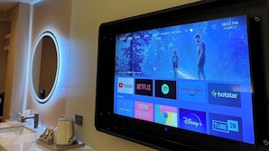A hotel room with a mounted tablet displaying streaming services and a mirror with LED lighting. - Star Hotel Pattaya (Pattaya)