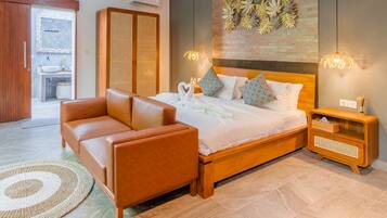 A modern bedroom with a wooden bed, a leather sofa, and a nightstand.