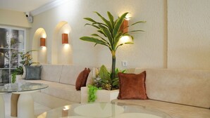 A modern living room with a glass coffee table, beige sofa, and a potted plant. - niXie Bodrum (Bodrum)