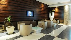 A modern lobby with a checkered floor, dark wood paneling, and contemporary furniture. - Empire Suite Subang by MyKey (Subang Jaya)