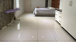 A spacious bedroom with a large bed, a wardrobe, and a vanity with a mirror. - Lautoka accommodation (Lautoka)