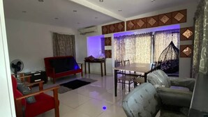A spacious living room with a red sofa, a grey patterned sofa, a dining table with chairs, and a ceiling with recessed lighting. - Lautoka accommodation (Lautoka)