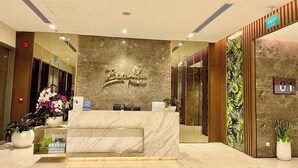 A reception area with a marble counter, potted plants, and a sign reading "Botanica Premier". - Nice Apartments near Tan Son Nhat Airpot (Ho Chi Minh City)