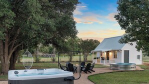 A hot tub, outdoor seating, a small house, and a pool. - Bubble Bungalow - Cowboy Pool, Hot Tub & Firepit! (Fredericksburg)