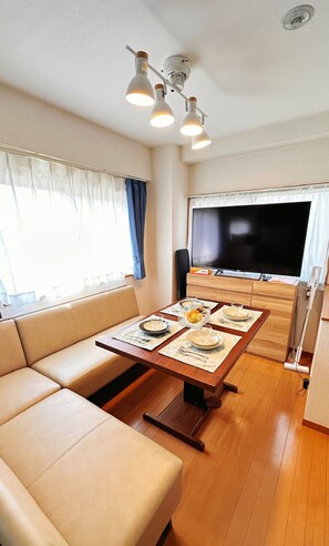 Family Apartment, 2 Bedrooms, Balcony | Living area | 43-inch LCD TV with cable channels, books - HYGGE HOUSE Traveler's house (Kashiwa)