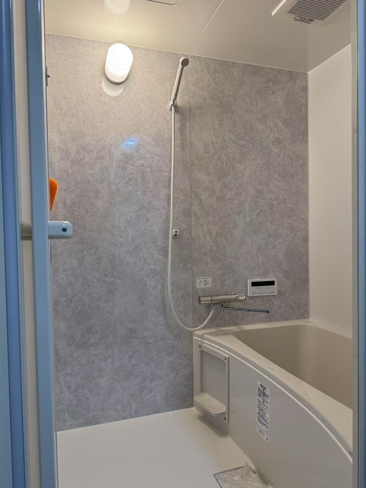 A modern bathroom with a walk-in shower, a bathtub, and a toilet.