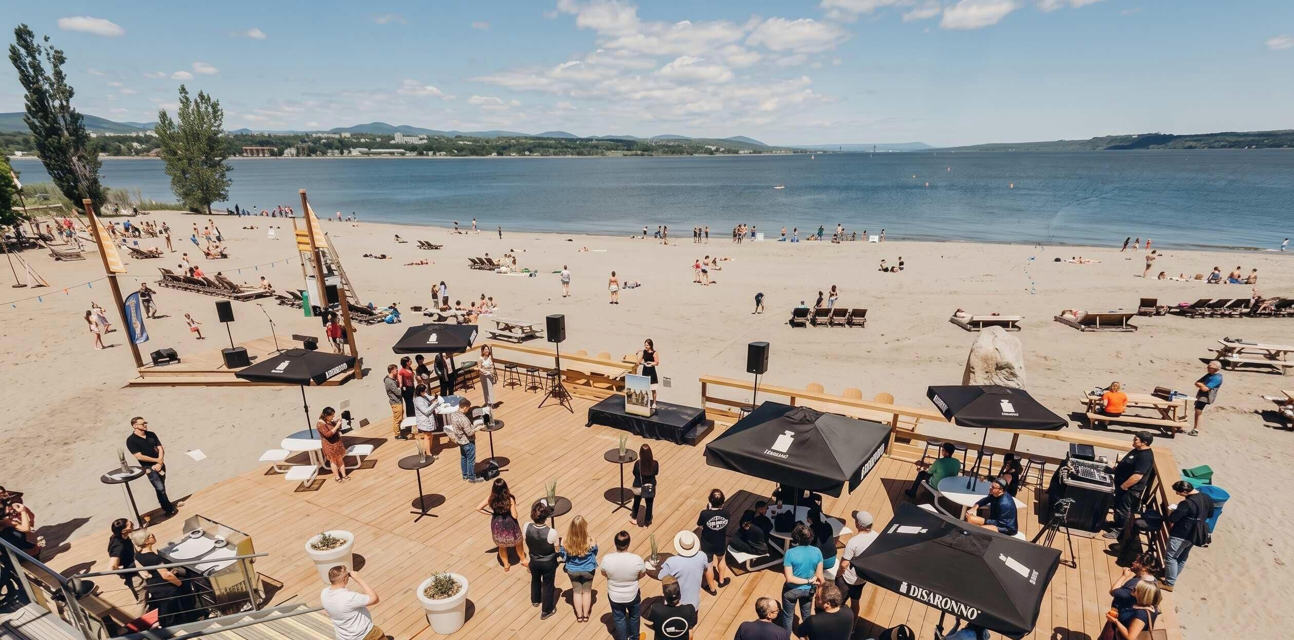 A beachside venue with outdoor seating, umbrellas, and a stage for events.