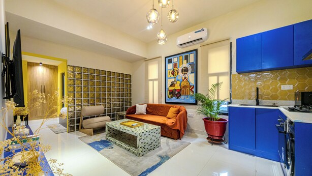 A modern living room with a sofa, coffee table, and decorative plants. - Glassvine (Lagos)