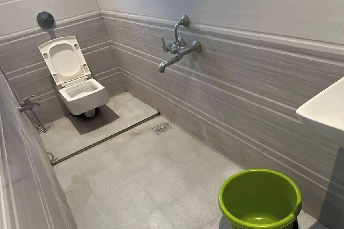 A modern bathroom with a toilet, bidet, and sink.