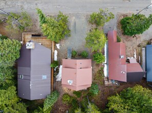 An aerial view of a residential area with houses, trees, and a road.