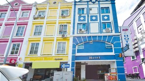A hotel with a blue facade, multiple air conditioning units, and a sign indicating it is a hotel. - KL2F Empire Hotel  Empire (Malacca City)