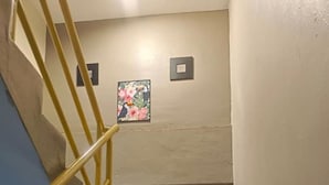 A staircase with alternating black and white steps, a yellow handrail, and a small framed picture on the wall. - KL2F Empire Hotel  Empire (Malacca City)