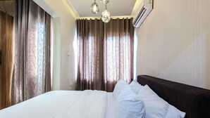 A hotel room with a large bed, dark headboard, and three pendant lights. - Glassvine - 2D (Lagos)