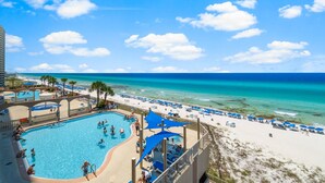 A resort with a swimming pool, beach, and ocean view. - Sunrise Beach 501-Corner Views, FREE Beach Service, Heated Pool, FREE Perks! (Panama City Beach)