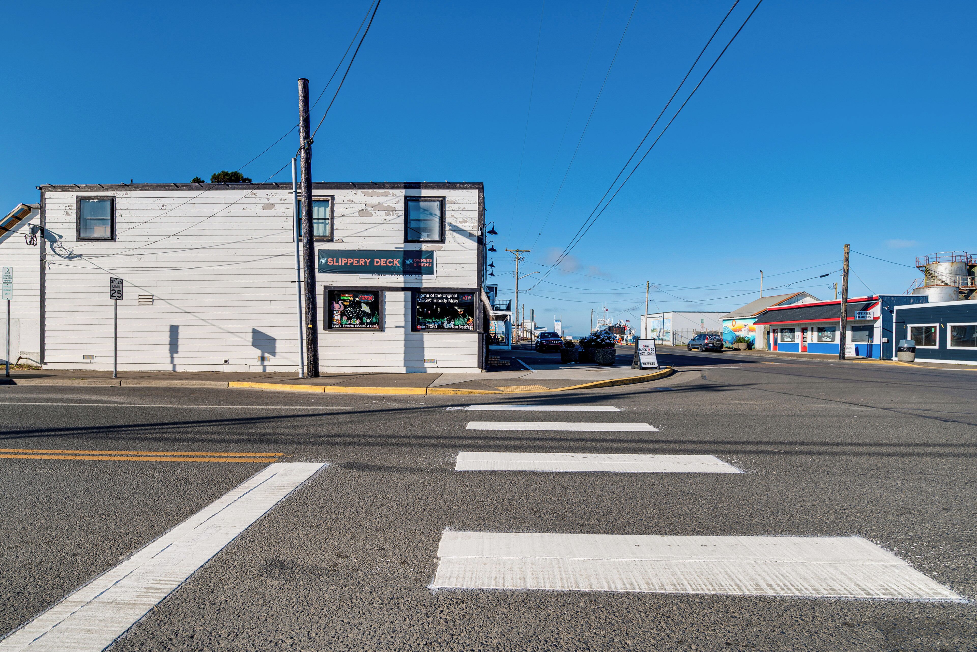 A street view with a building labeled 'The Slippery Deck' and a speed limit sign of 25 mph.
