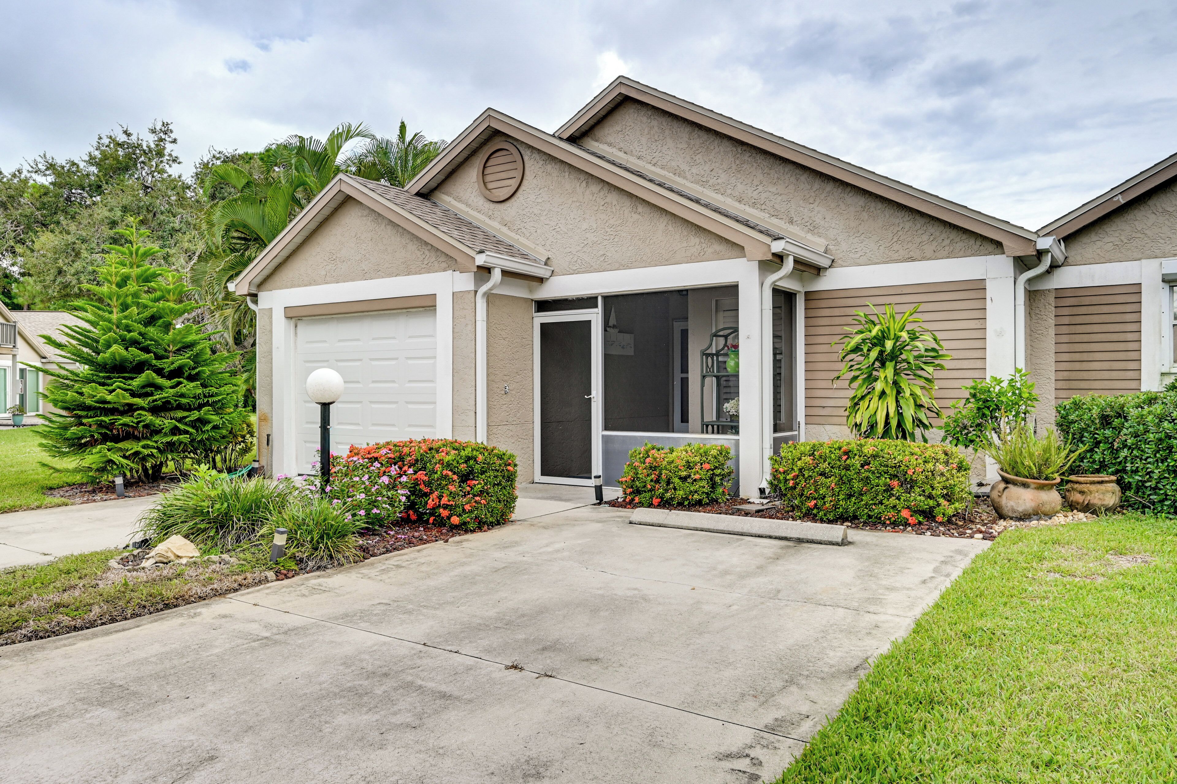 A single-story house with a garage, a front door, and a small porch area.