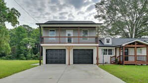 A two-story house with a front porch, a garage, and a small attached structure. - 12 Mi to Downtown Winston-salem: Apt w/ Balcony! (Winston-Salem)
