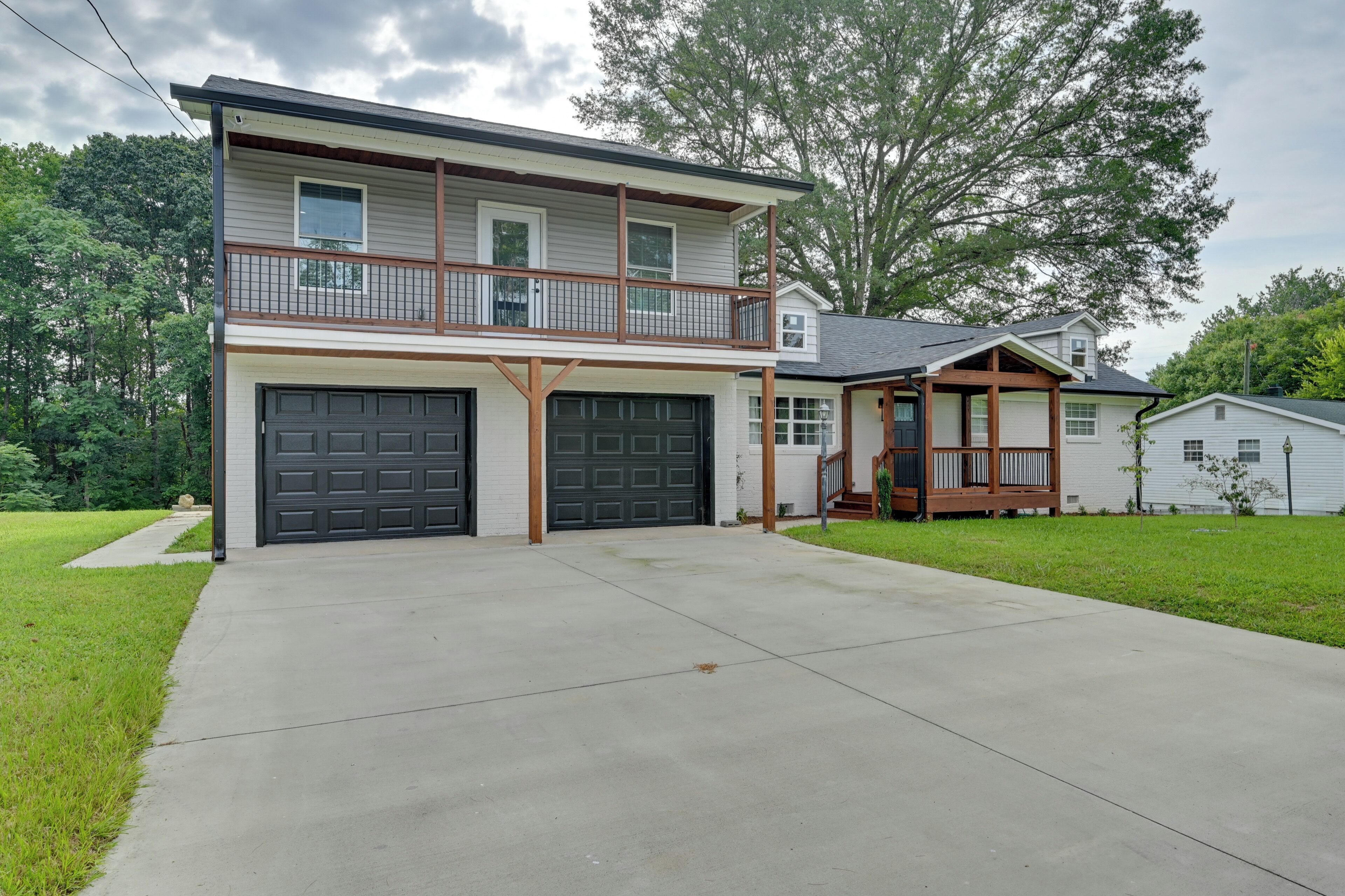 A two-story house with a front garage, a balcony, and a small porch.