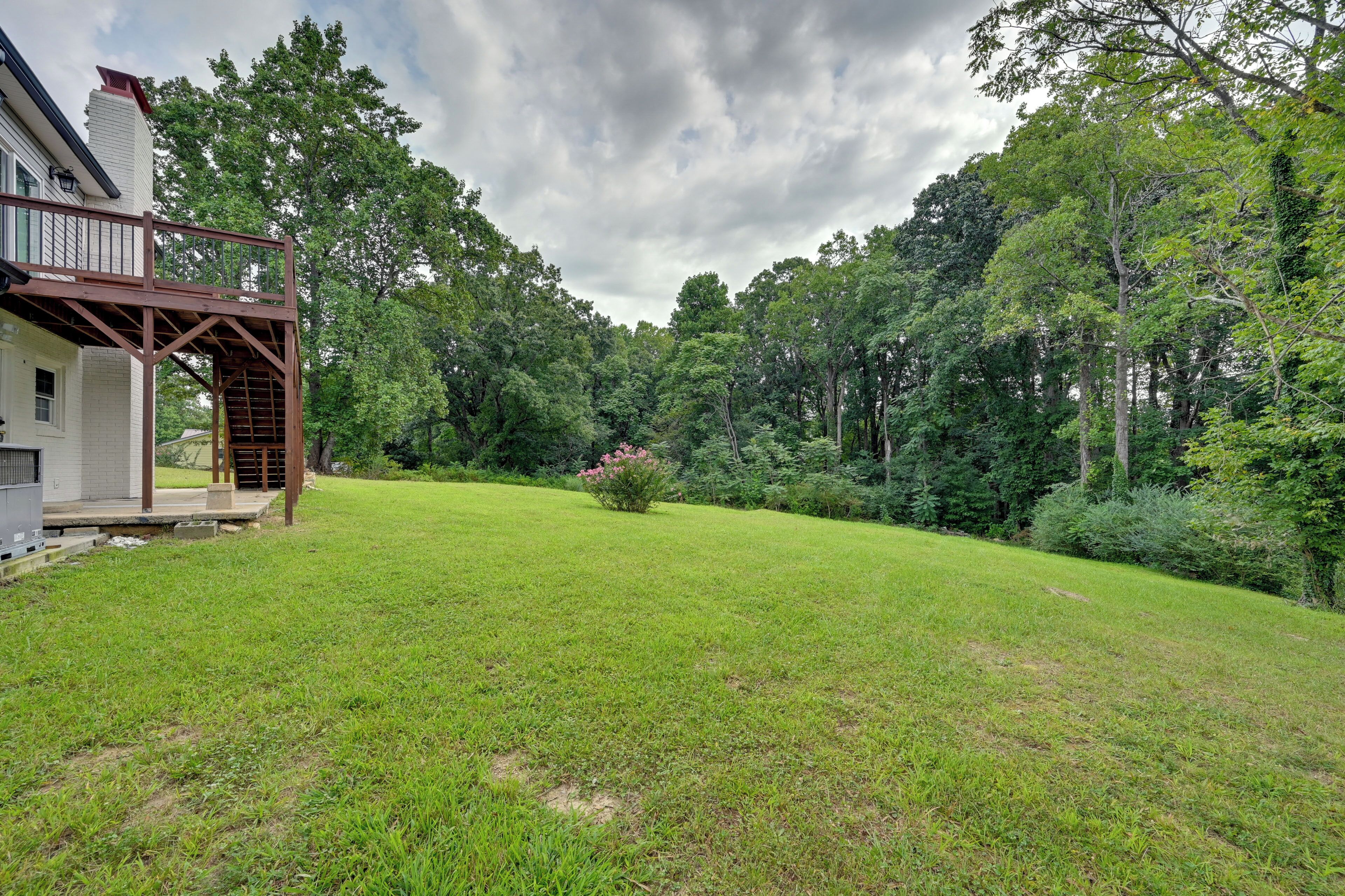 A house with a covered porch and a well-maintained lawn.